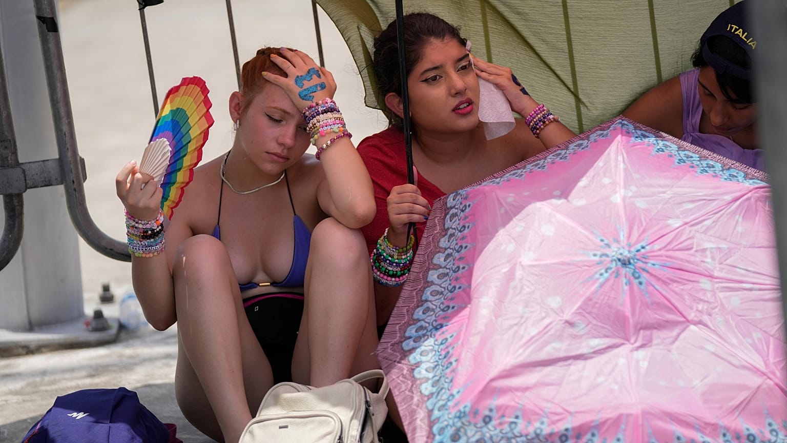 Taylor Swift fans wait for the doors of the Nilton Santos Olympic stadium to open amid a heat wave in Rio de Janeiro in November. 