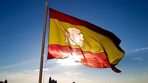 A Spanish flag flies above part of the Madrid skyline, Monday July 2, 2012.