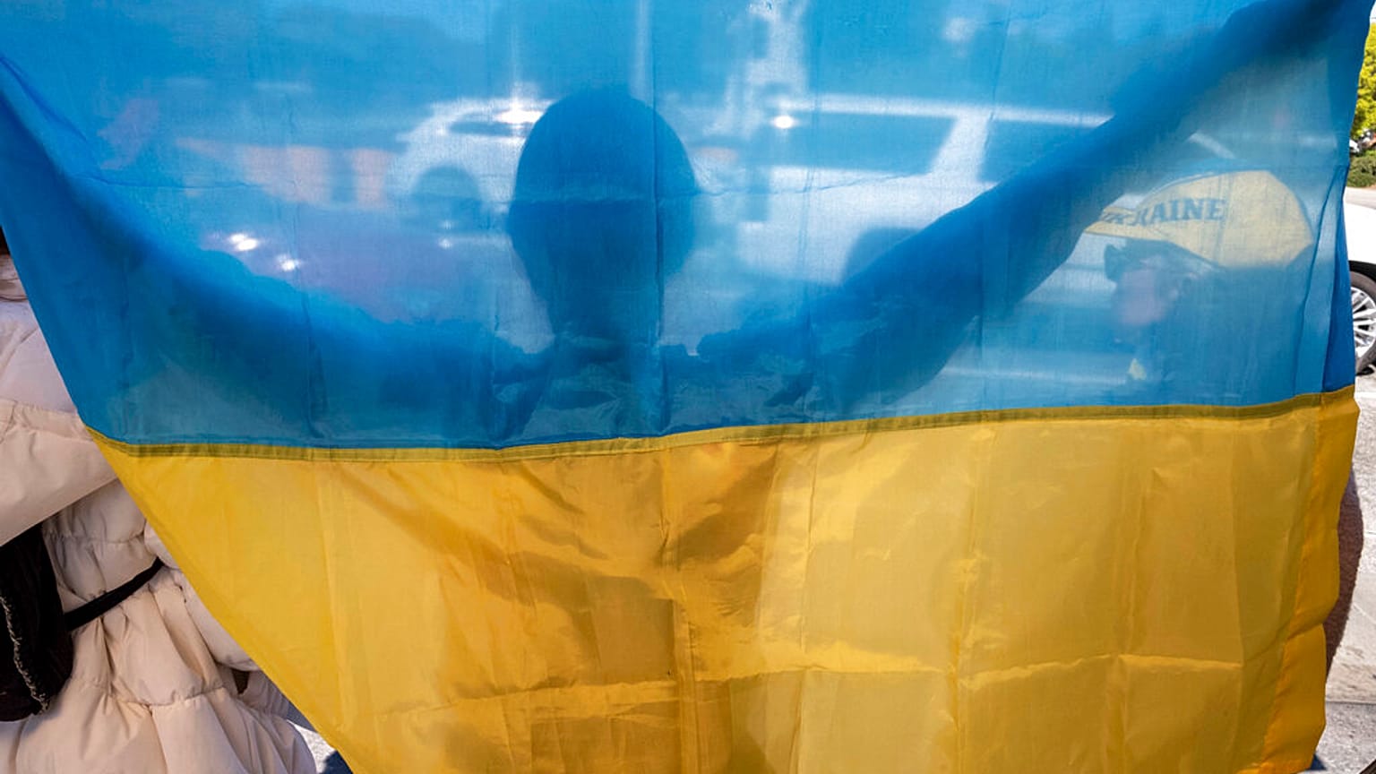Protestors calling for a stop to the Russian invasion of Ukraine appeal to motorists outside of the federal building in Los Angeles Thursday, Feb. 24, 2022.