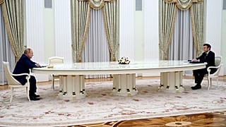 FILE - Russian President Vladimir Putin, left, listens to French President Emmanuel Macron during their meeting in the Kremlin in Moscow, Russia, Feb. 7, 2022.
