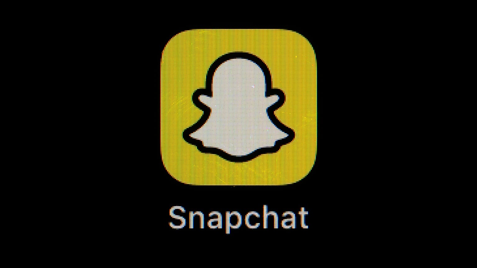 The icon for instant messaging app Snapchat is seen on a smartphone.