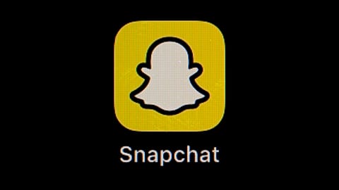 The icon for instant messaging app Snapchat is seen on a smartphone.