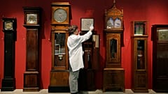 A conservator adjusts clocks in the Science Museum's Measuring Time gallery in London, October 2012.