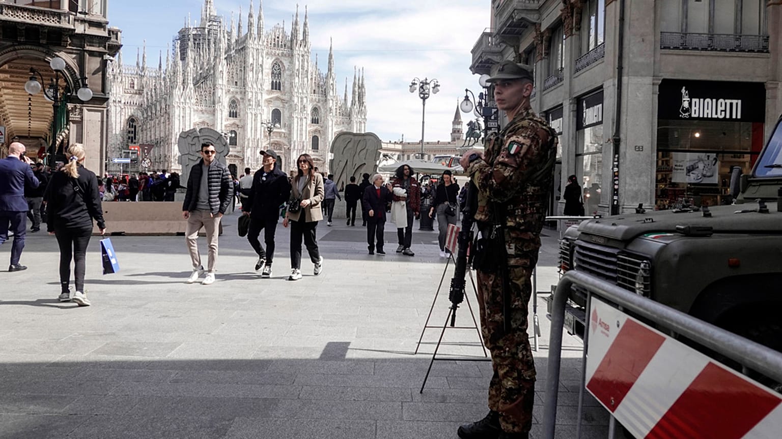 A soldier patrols in front of Milan gothic cathedral in Milan, Monday, March 25, 2024