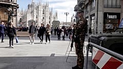 A soldier patrols in front of Milan gothic cathedral in Milan, Monday, March 25, 2024