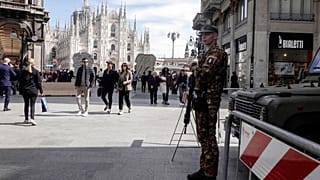 A soldier patrols in front of Milan gothic cathedral in Milan, Monday, March 25, 2024