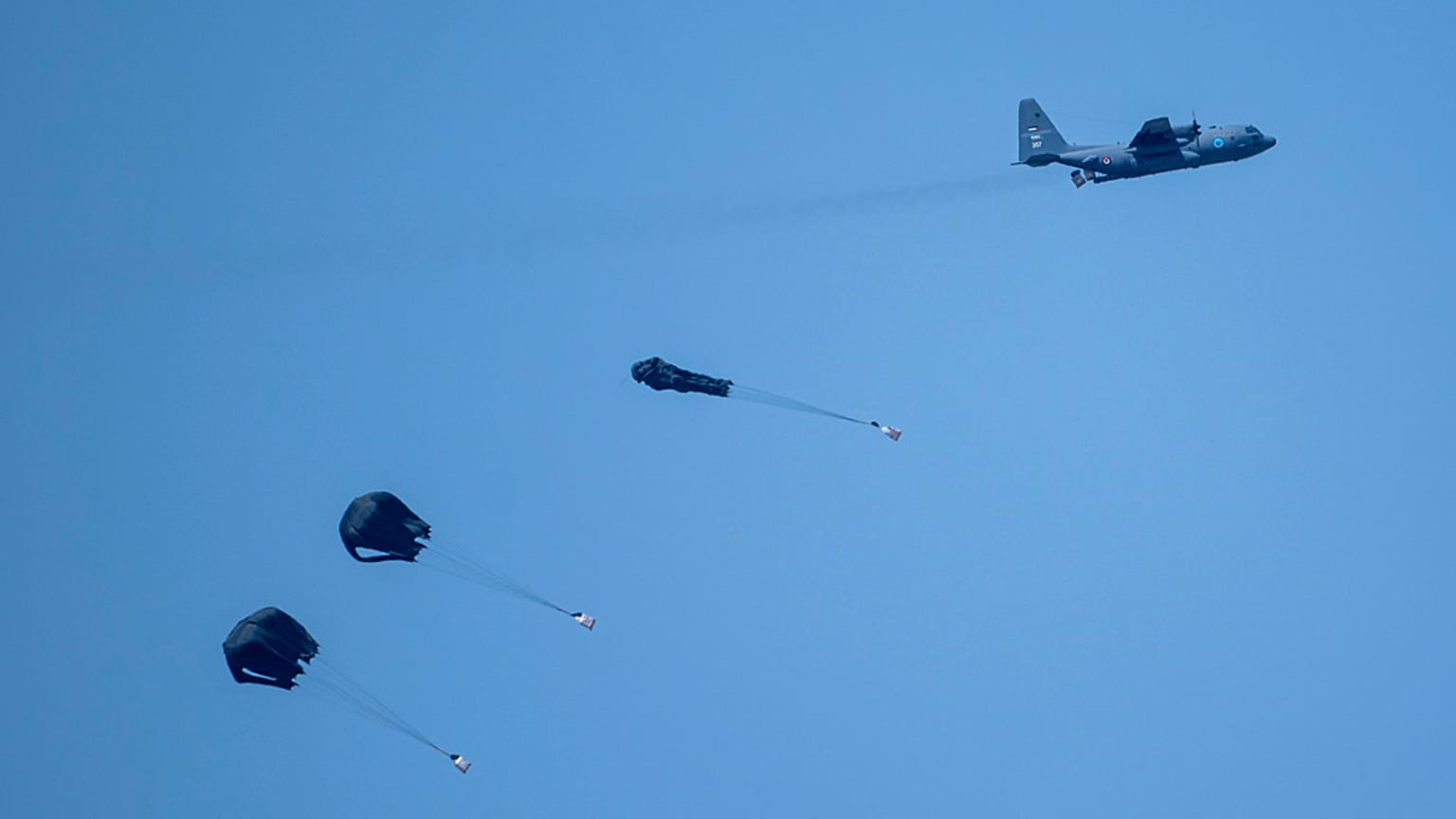 An aircraft airdrops humanitarian aid over northern Gaza Strip as seen from southern Israel, Thursday, March 28, 2024. 