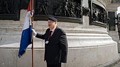 A protester hold a French flag during a pro police demonstration, on Republique square, in Paris, Saturday, Sept. 30, 2023. 