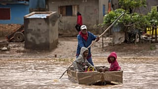 People paddle through floodwaters after cyclone Gamane hit northern Madagascar, March 28th 2024
