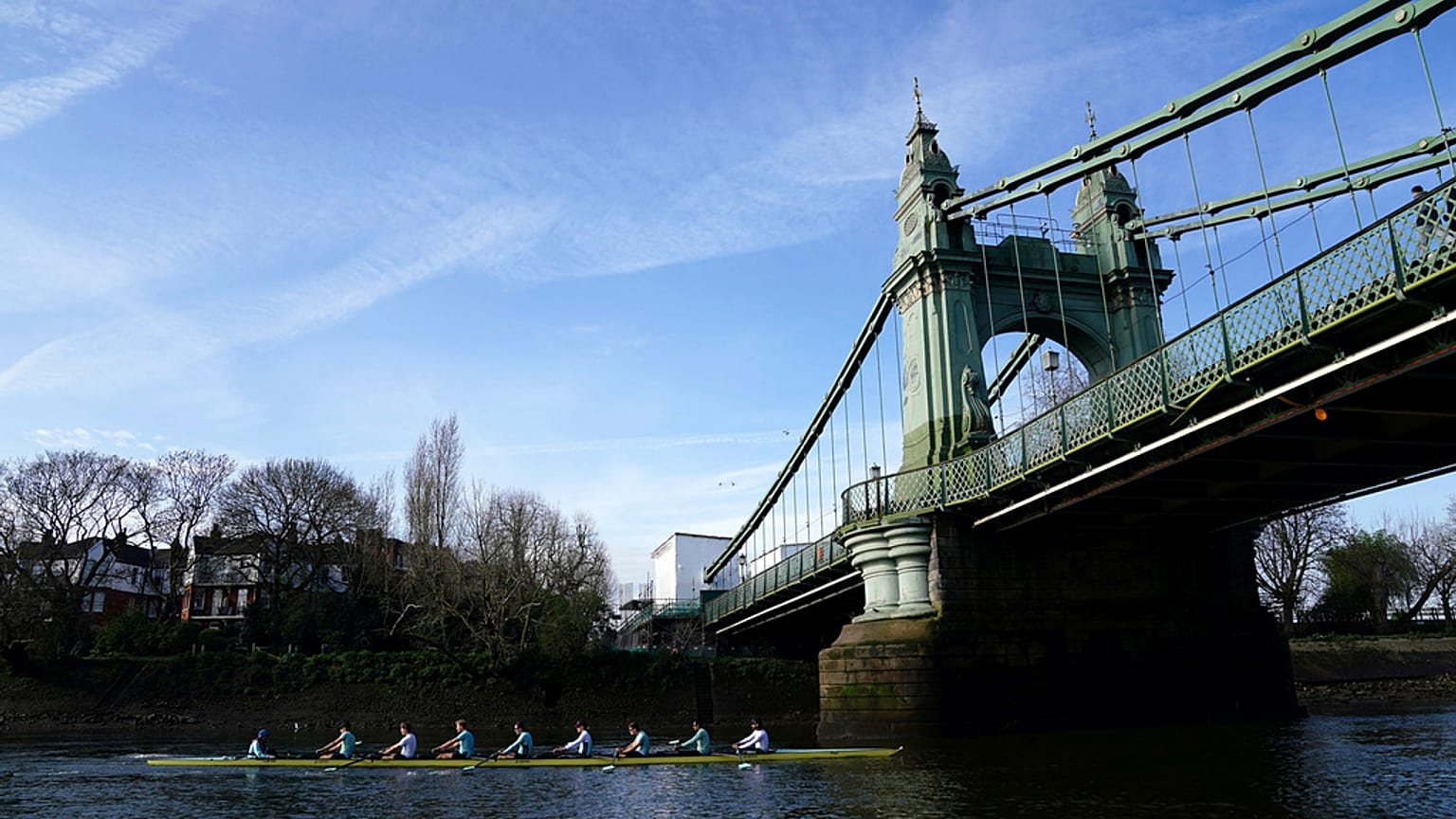 The Cambridge men's team pass under Hammersmith Bridge during a training session on the River Thames in London on Tuesday