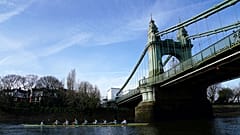 The Cambridge men's team pass under Hammersmith Bridge during a training session on the River Thames in London on Tuesday