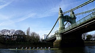The Cambridge men's team pass under Hammersmith Bridge during a training session on the River Thames in London on Tuesday