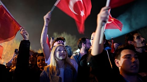Supporters listen to Istanbul Mayor and Republican People's Party, or CHP, candidate Ekrem Imamoglu outside the City Hall in Istanbul, Turkey, early Monday, April 1, 2024.