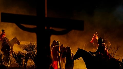 Faithful take part in a Way of the Cross reenactment as part of Holy Week celebrations, in Colina, Chile, Friday, March 29, 2024