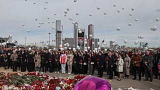 A group of ambassadors of foreign diplomatic missions attend a laying ceremony at a makeshift memorial in front of the Crocus City Hall 