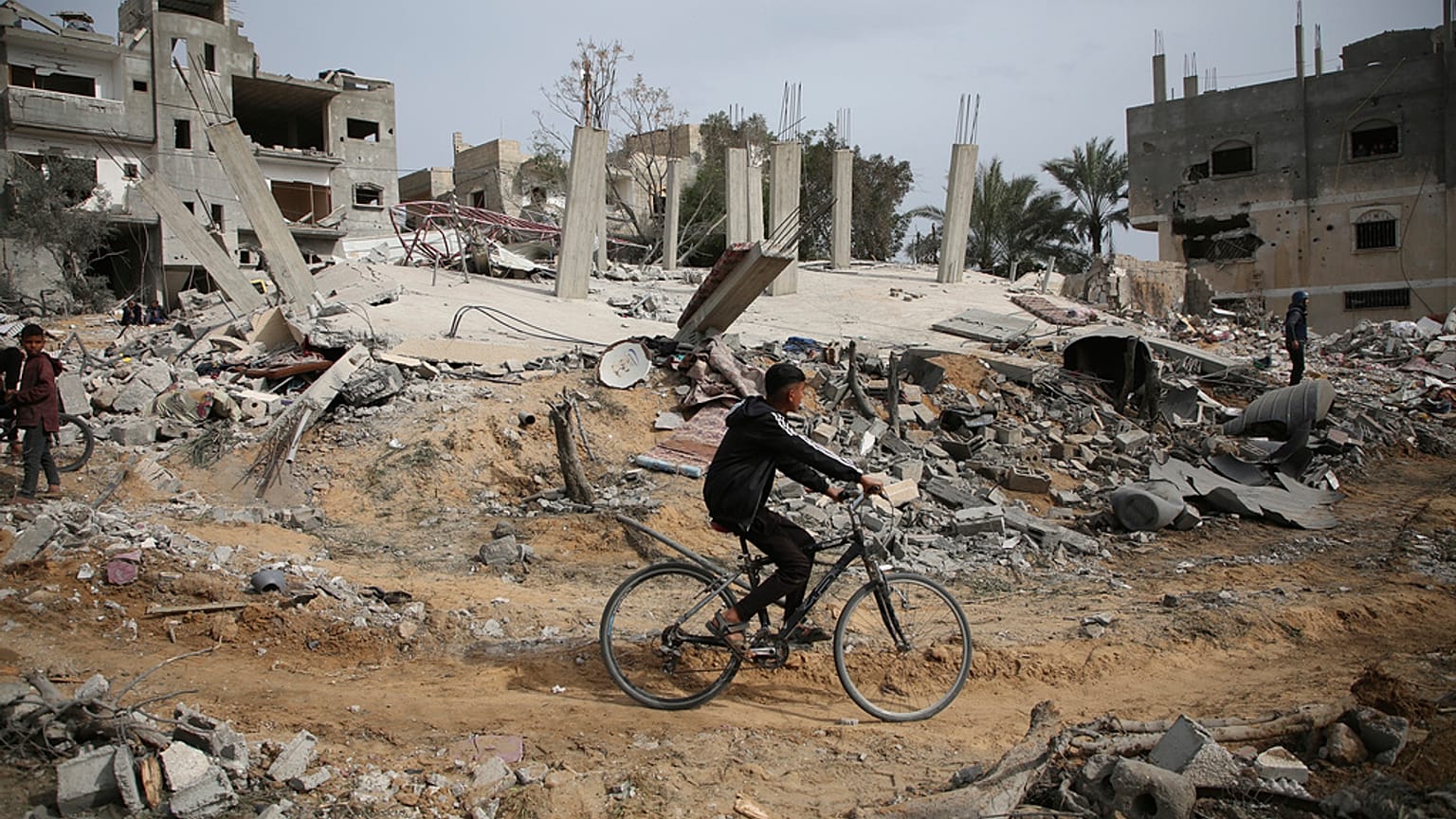 فلسطينيون يتفقدون أنقاض مبنى سكني لعائلة أبو معمر بعد غارة جوية إسرائيلية في رفح، جنوب قطاع غزة، الجمعة، 29 مارس، 2024. 