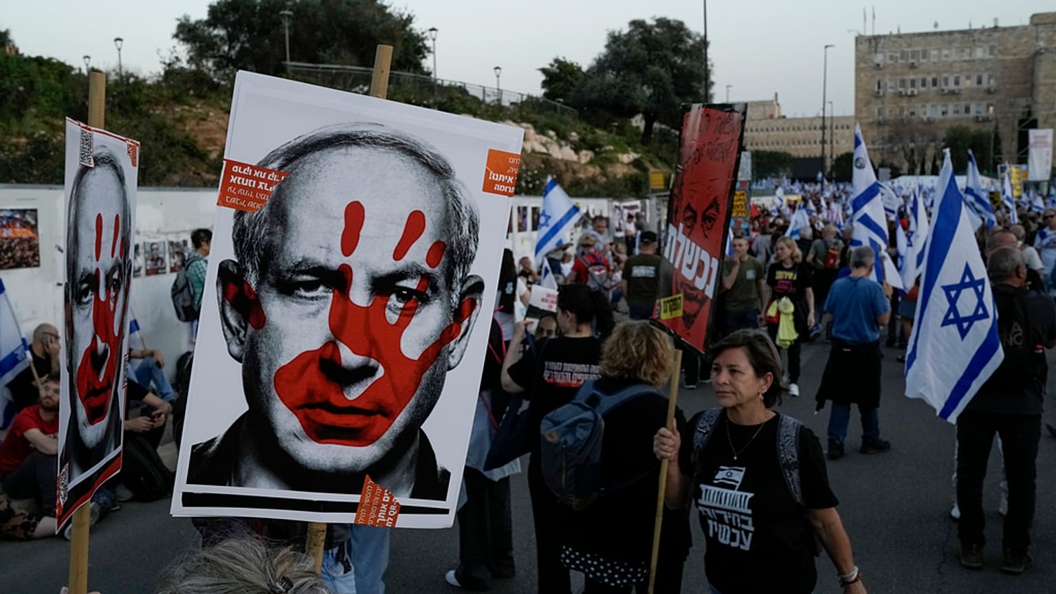People take part in a protest against Israeli Prime Minister Benjamin Netanyahu's government  in Jerusalem, Sunday, March 31, 2024. 