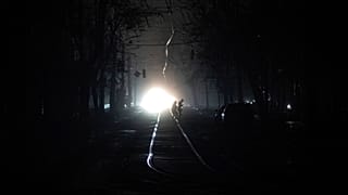 People cross the road at the city center which lost electrical power after yesterday's Russian rocket attack in Kyiv, Ukraine, Thursday, Nov. 24, 2022.
