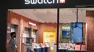 A man walk pass Swatch outlet at a shopping mall in Putrajaya, Malaysia, Thursday, Aug. 10, 2023.