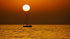 Sunset lover: A boat sails near Stromboli, Aeolian islands