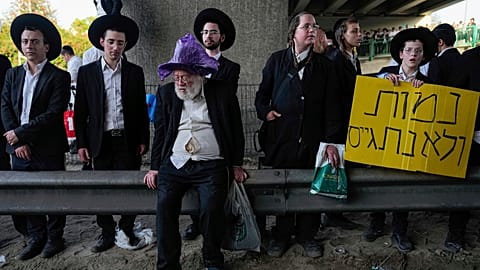 Ultra-Orthodox Jews block a highway during a protest against army recruitment, near Bnei Brak, Israel,