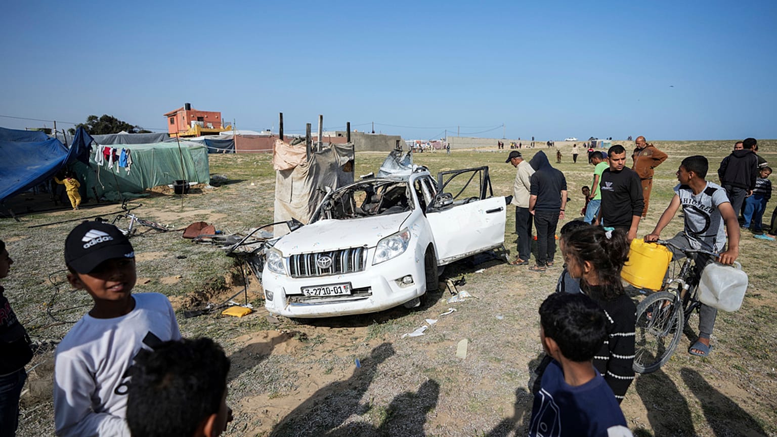 People inspect the site where World Central Kitchen workers were killed in Deir al-Balah, Gaza Strip, Tuesday, April 2, 2024