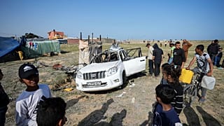 People inspect the site where World Central Kitchen workers were killed in Deir al-Balah, Gaza Strip, Tuesday, April 2, 2024