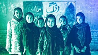 Afghan schoolgirls pose for a photo in a classroom in Kabul, December 2022