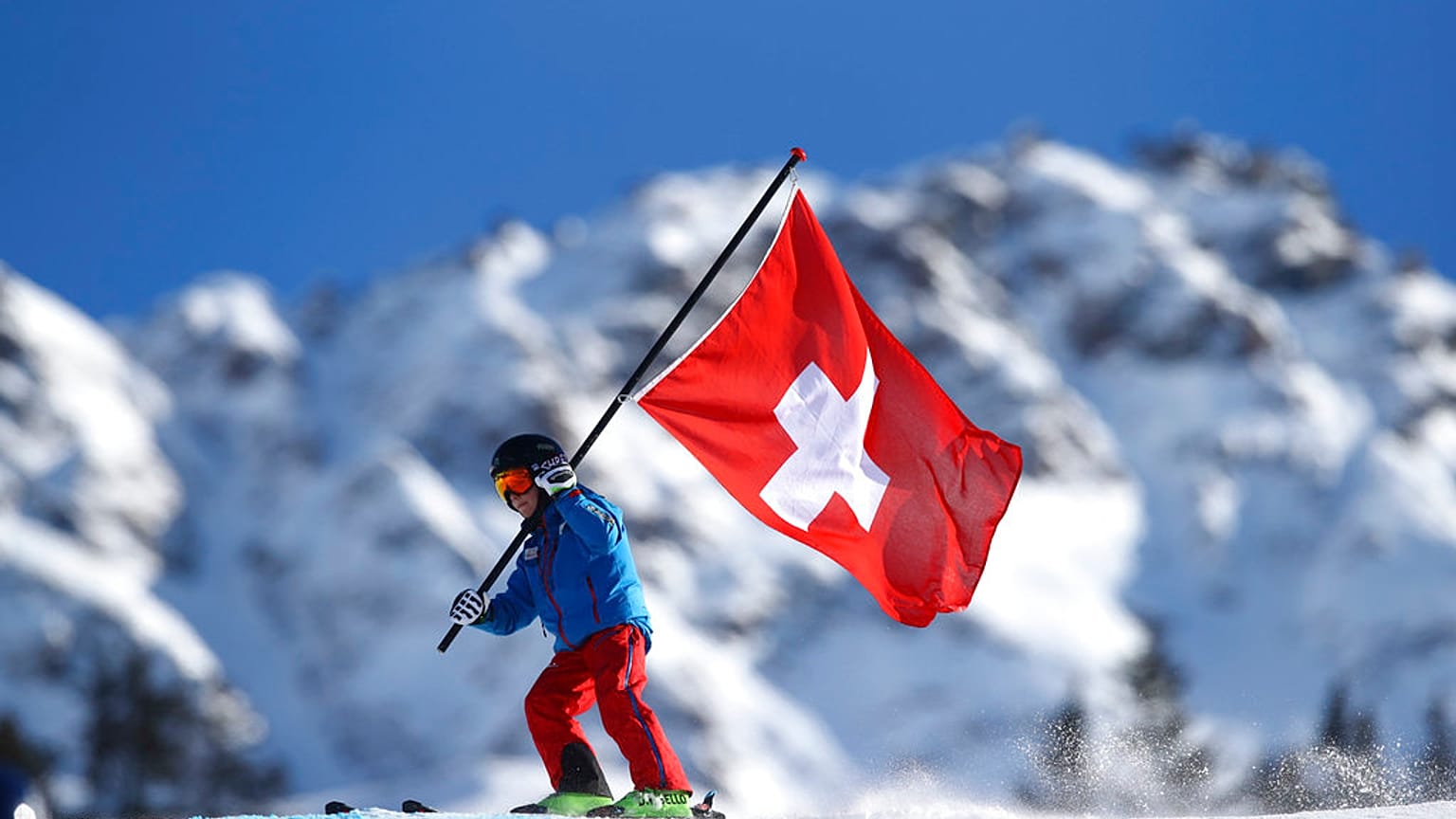 A young Swiss supporter hold a Swiss banner prior to the start of alpine ski, women's World Cup giant slalom, in Lenzerheide, Switzerland, Saturday, Jan. 27, 2018.