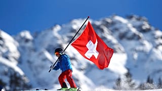 A young Swiss supporter hold a Swiss banner prior to the start of alpine ski, women's World Cup giant slalom, in Lenzerheide, Switzerland, Saturday, Jan. 27, 2018.
