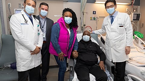 Rick Slayman sits with doctors from Massachusetts General Hospital and his partner.