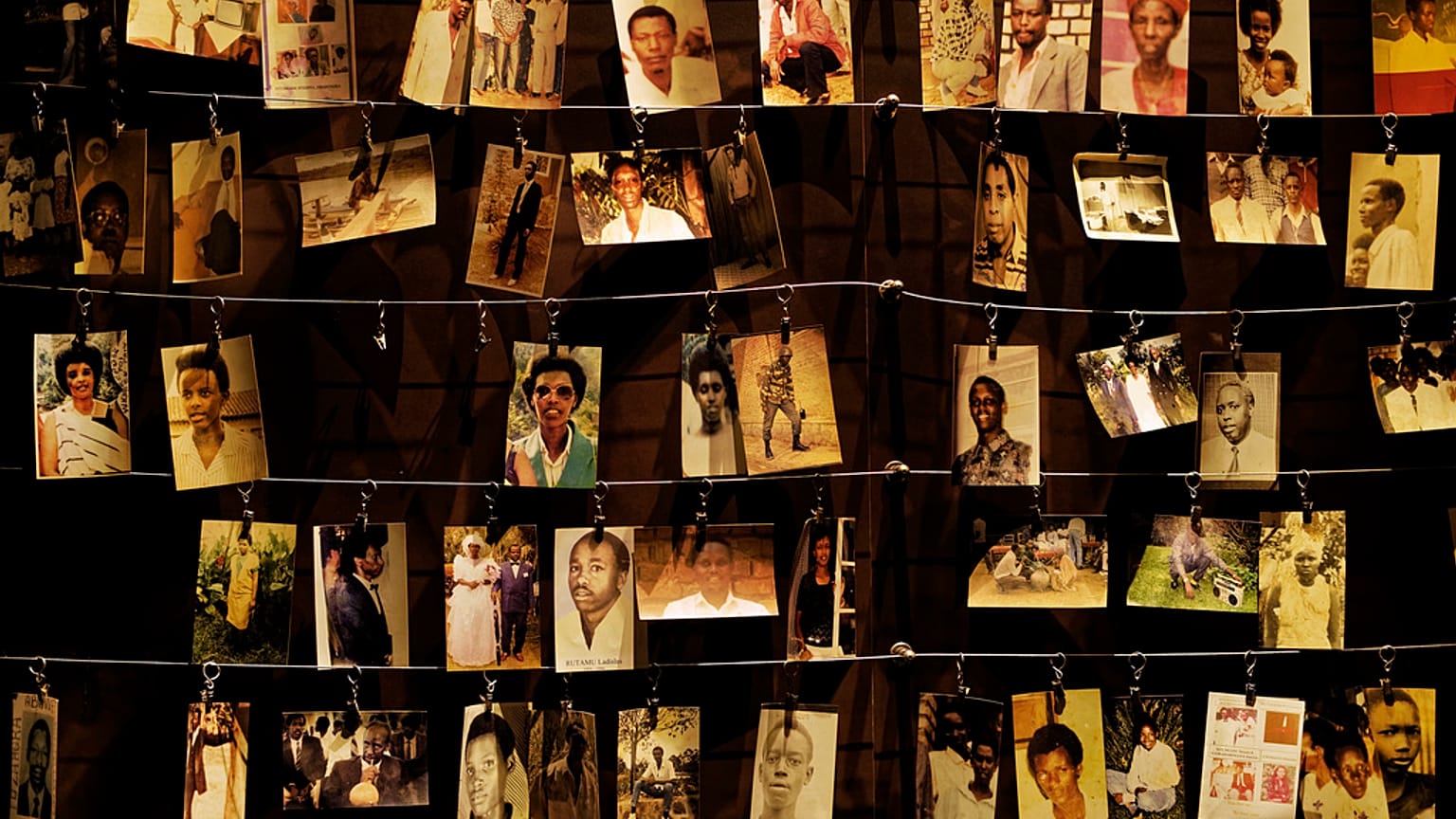 In this Friday, April 5, 2019 file photo, family photographs of some of those who died hang on display in an exhibition at the Kigali Genocide Memorial centre in Kigali