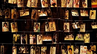 In this Friday, April 5, 2019 file photo, family photographs of some of those who died hang on display in an exhibition at the Kigali Genocide Memorial centre in Kigali