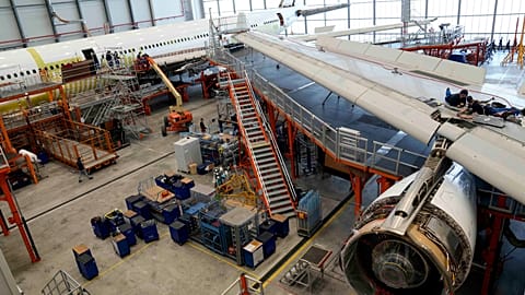 Employees work on an aircraft at the Elbe Aircraft Factory during a visit of German chancellor Olaf Scholz in Dresden, Germany, Thursday, Feb. 29, 2024. 