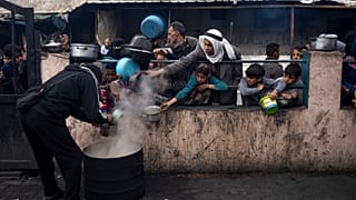 Palestinians line up for a free meal in Rafah, Gaza Strip
