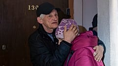 Husband comforts Liubov, 67, while they are hiding on a first floor of a residential house, during the air alarm after Russian attack in Kharkiv