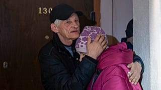 Husband comforts Liubov, 67, while they are hiding on a first floor of a residential house, during the air alarm after Russian attack in Kharkiv