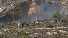 Citizens attempting to put out the weekend wildfire on the Greek island of Crete.  
