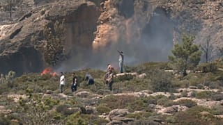 Citizens attempting to put out the weekend wildfire on the Greek island of Crete.