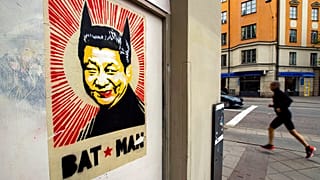 A poster depicting Chinese President Xi Jinping with two pointed ears underlined by the words "BAT MAN" on a street in Stockholm, Wednesday, May 6, 2020..