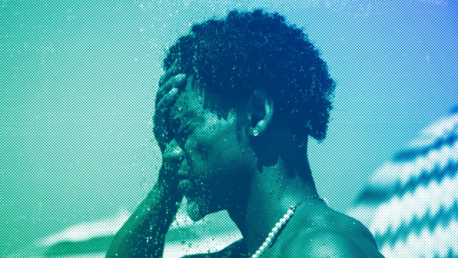 A man cools off in a shower at Ipanema beach, Rio de Janeiro, September 2023