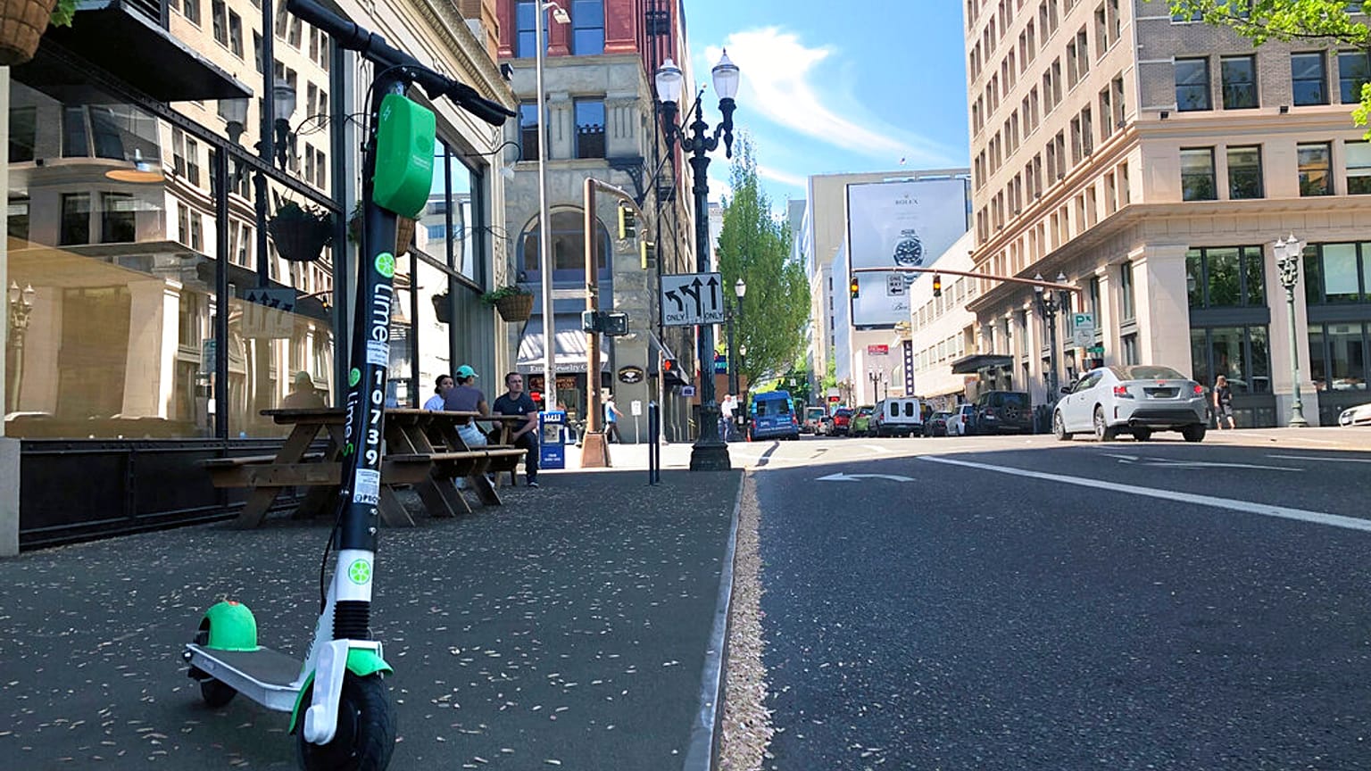 A Lime e-scooter sits parked on a street in downtown Portland, Ore., Thursday, May 9, 2019.