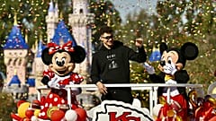Kansas City Chiefs quarterback Patrick Mahomes, center, greets fans on Main Street, U.S.A, during a cavalcade through Disneyland in Anaheim, Calif., Monday, Feb. 12, 2024. 
