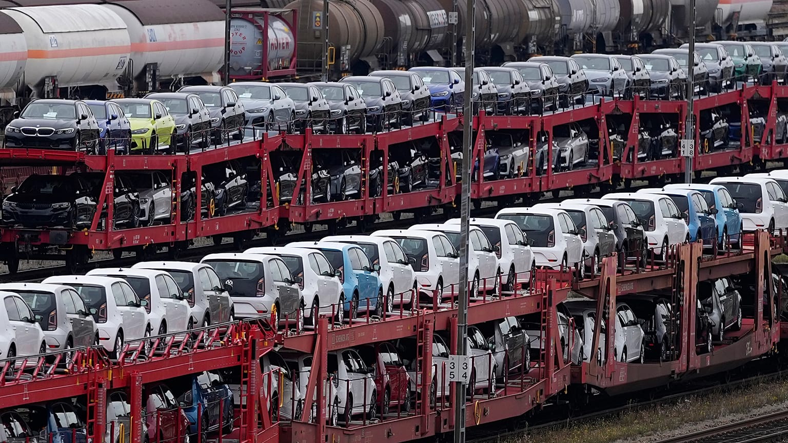 German cars created by Volkswagen and BMW are parked on a freight train in Munich, Germany. Oct. 14, 2021.