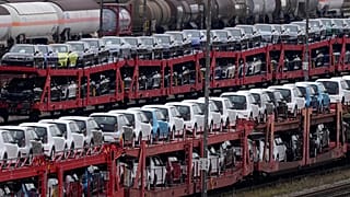 German cars created by Volkswagen and BMW are parked on a freight train in Munich, Germany. Oct. 14, 2021.