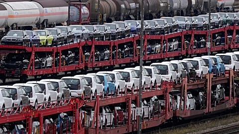 German cars created by Volkswagen and BMW are parked on a freight train in Munich, Germany. Oct. 14, 2021.