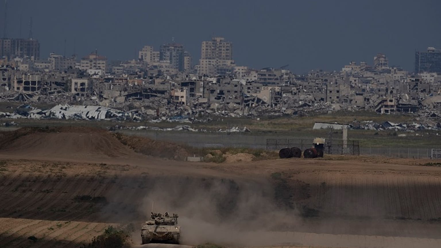 Israeli soldiers move on the top of a tank near the Israeli-Gaza border, as seen from southern Israel, Tuesday, April 9, 2024