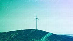 A road leads past a wind turbine stands on the Aegean island of Tilos, August 2018