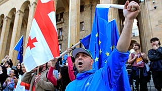 Protesters gather outside the parliament building in Tbilisi.