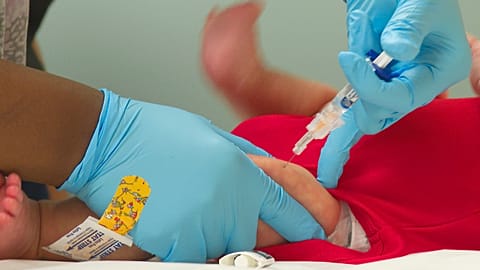 An infant receives a routine vaccination in 2021.